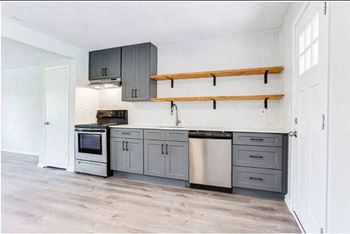a kitchen with gray cabinets and white walls  at The Oasis on Cascade, Atlanta, 30310