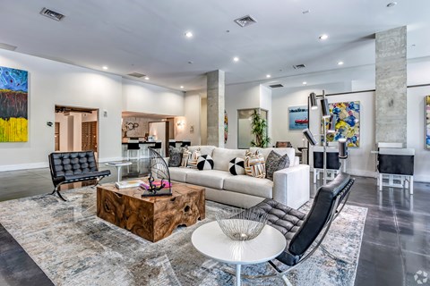 A modern living room with a black leather chair and a wooden coffee table.