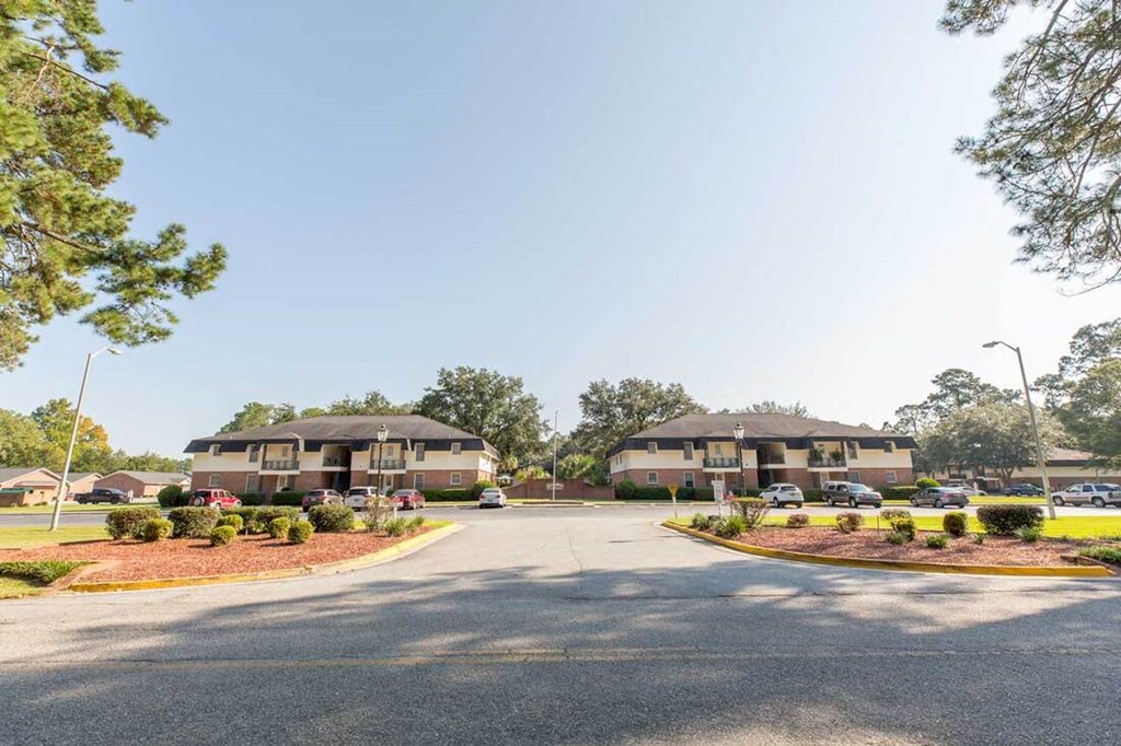 A large building with a parking lot in front of it.