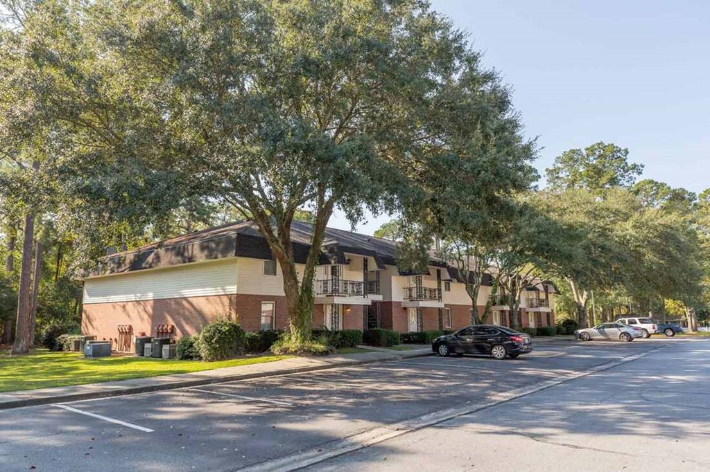 A black car is parked on the side of a street.