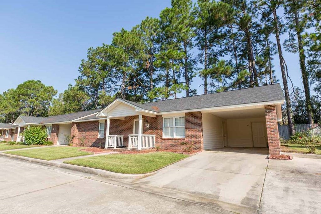 A house with a brick facade and a covered porch.
