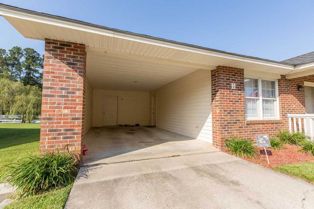 A house with a garage and a brick pillar.