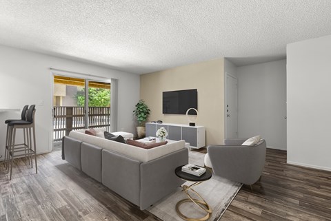 A living room with a grey couch and a grey armchair.