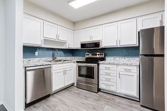Kitchen with appliances and cabinets Kitchen with appliances and cabinets at Parks At Utoy Creek, Georgia, 30331 - Photo Gallery