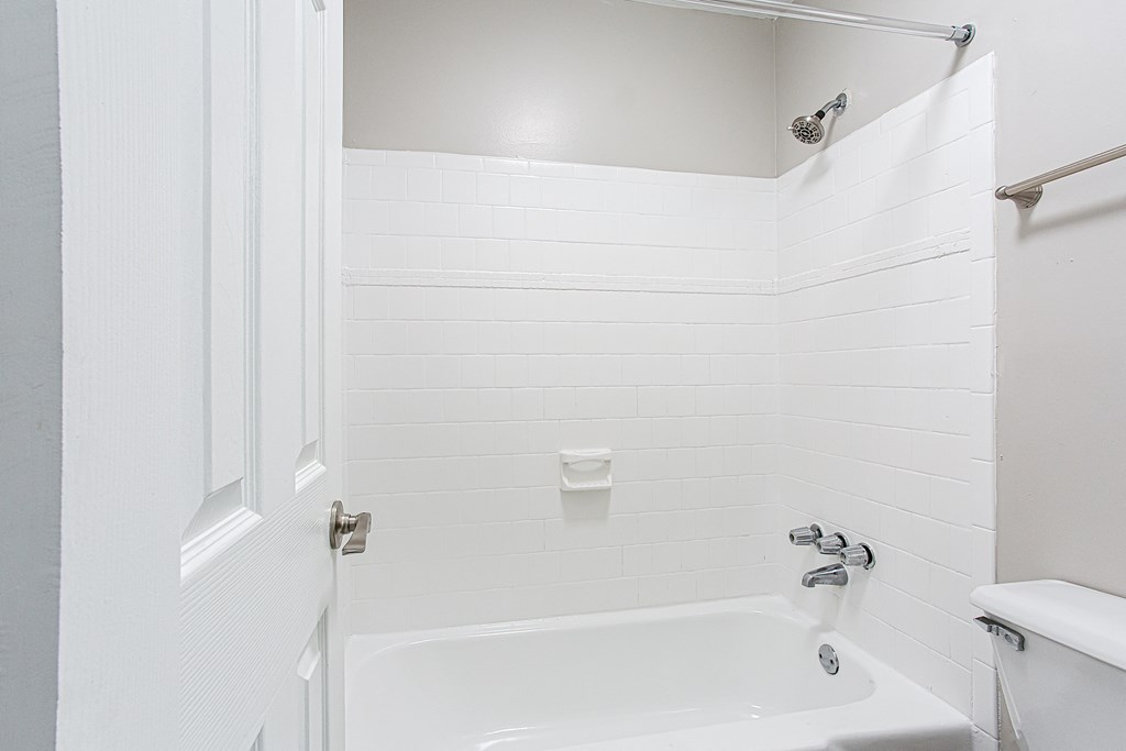 Spacious tub and shower with tiled walls Spacious tub and shower with tiled walls at Parkside at Sandy Springs Atlanta, GA