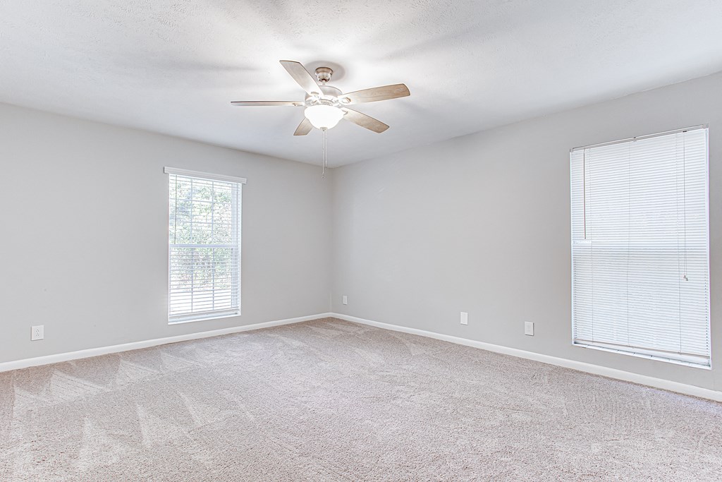 Spacious bedroom with ceiling fan and carpet Spacious bedroom with ceiling fan and carpet at Parkside at Sandy Springs Atlanta, GA