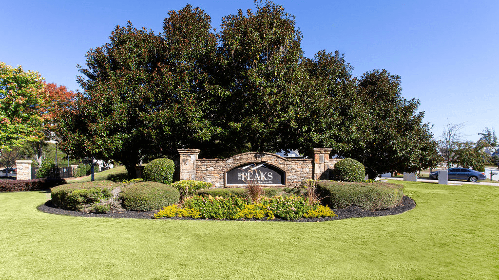a park with a sign in front of a building  at Peaks at Gainesville, Gainesville, Georgia
