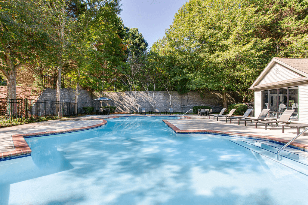 a swimming pool with chairs and a house in the background  at Peaks at Gainesville, Gainesville, 30507