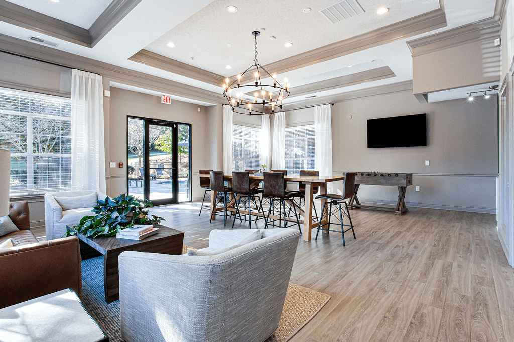 a living room with a table and chairs and a television  at Peaks at Gainesville, Gainesville, Georgia
