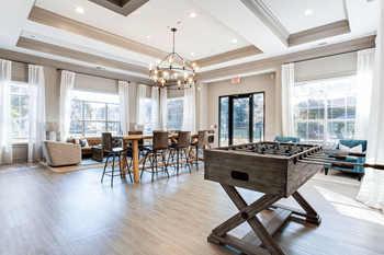 a game room with a foosball table in the center of it at Peaks at Gainesville, Gainesville, GA