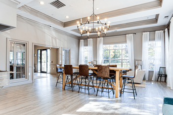 a dining room with a wooden table and chairs and a chandelier at Peaks at Gainesville, Gainesville, GA, 30507