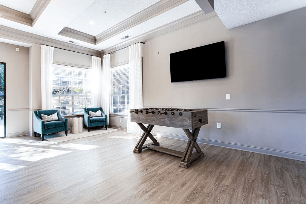 a game room with a foosball table and a tv  at Peaks at Gainesville, Gainesville, GA, 30507