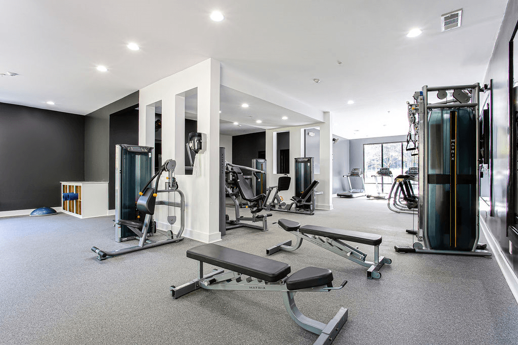 a gym with weights and cardio equipment in a building  at Peaks at Gainesville, Gainesville, Georgia