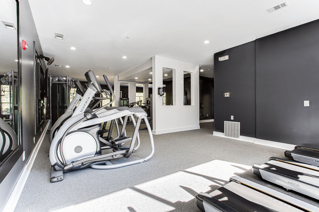 a gym with a lot of equipment on the floor  at Peaks at Gainesville, Georgia