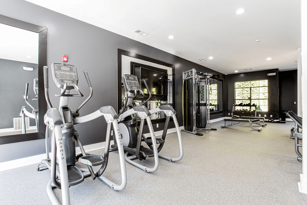 a gym with weights and cardio equipment in a building  at Peaks at Gainesville, Gainesville, GA
