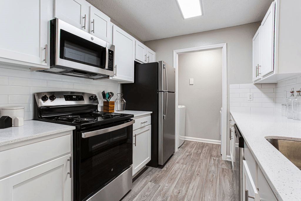 a kitchen with black appliances and white cabinets  at Peaks at Gainesville, Gainesville, GA, 30507