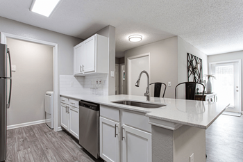 an open kitchen with white cabinets and a large counter top at Peaks at Gainesville, Gainesville, GA, 30507