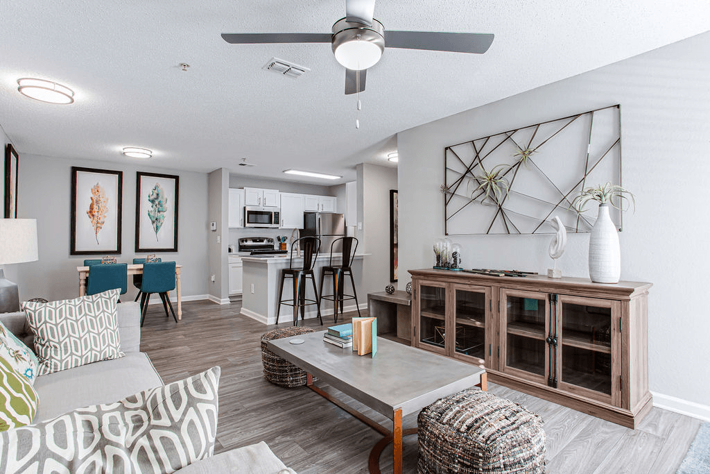 an open living room and kitchen with a ceiling fan  at Peaks at Gainesville, Gainesville, Georgia