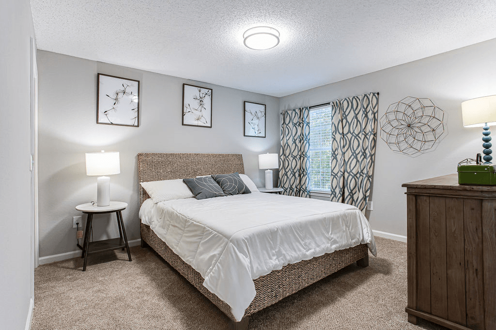 a bedroom with a bed and a window  at Peaks at Gainesville, Gainesville, GA