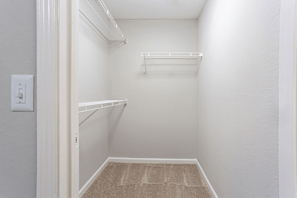 a spacious walk in closet in a white room with shelves  at Peaks at Gainesville, Gainesville, 30507