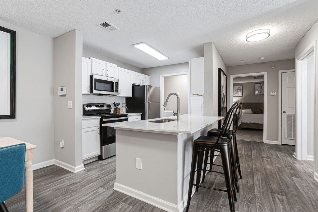 a kitchen with a large island with bar stools  at Peaks at Gainesville, Gainesville, Georgia