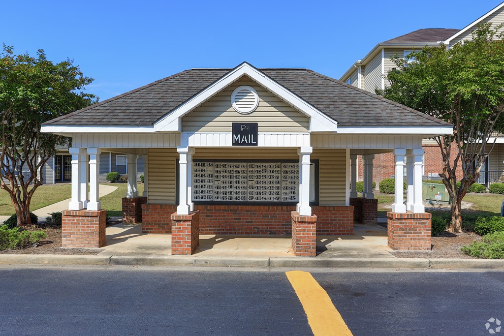 a small building with a sign on it on the side of a street
