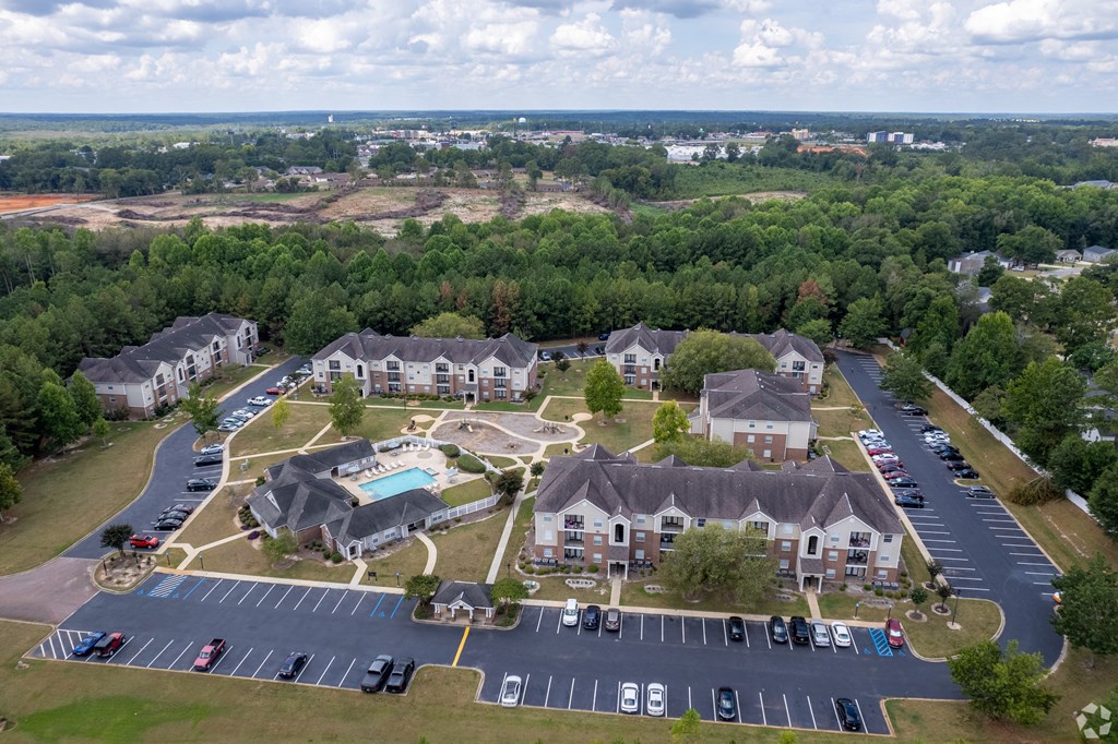 an aerial view of a group of houses and a parking lot