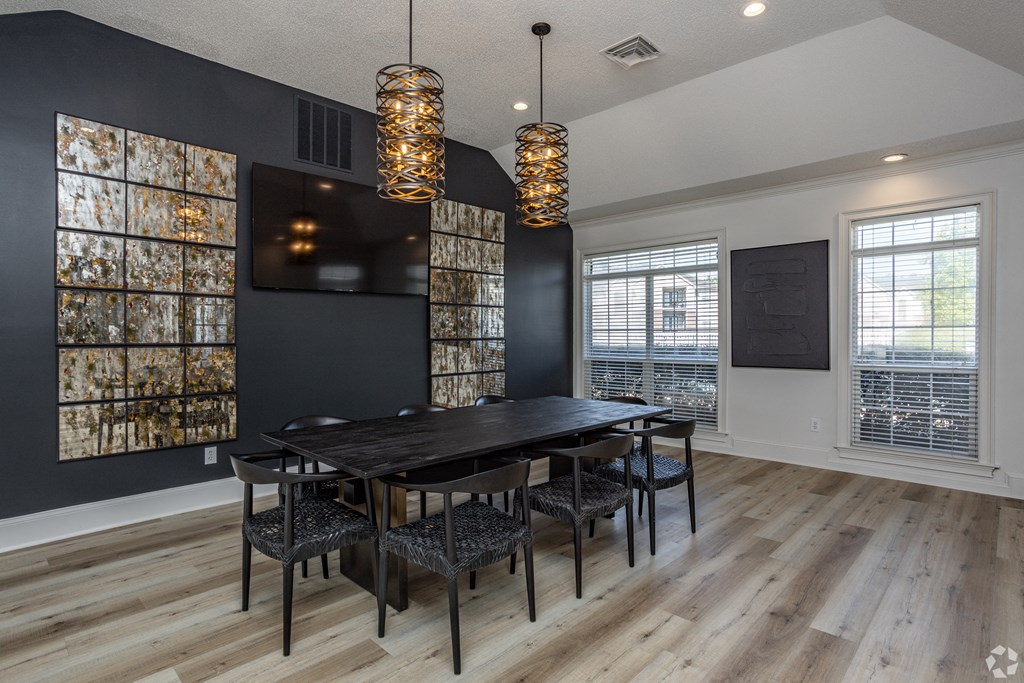 an image of a dining room with a table and chairs