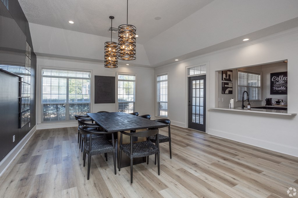a dining room with a table and chairs and a large window