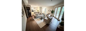 A living room with a white couch and a coffee table.
