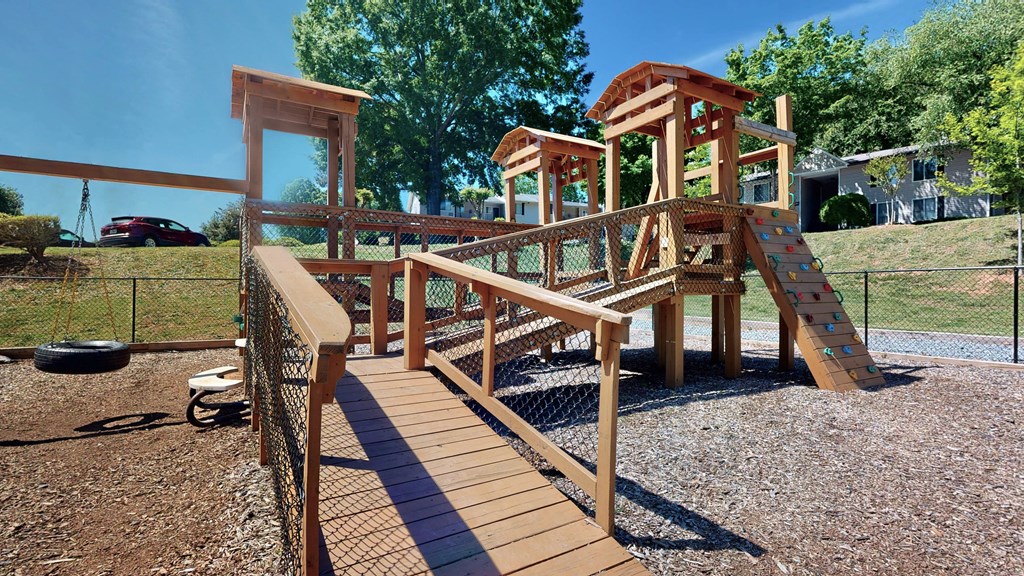 a wooden stairway leading up to a climbing structure in a park at Vue on Medlock, Peachtree Corners