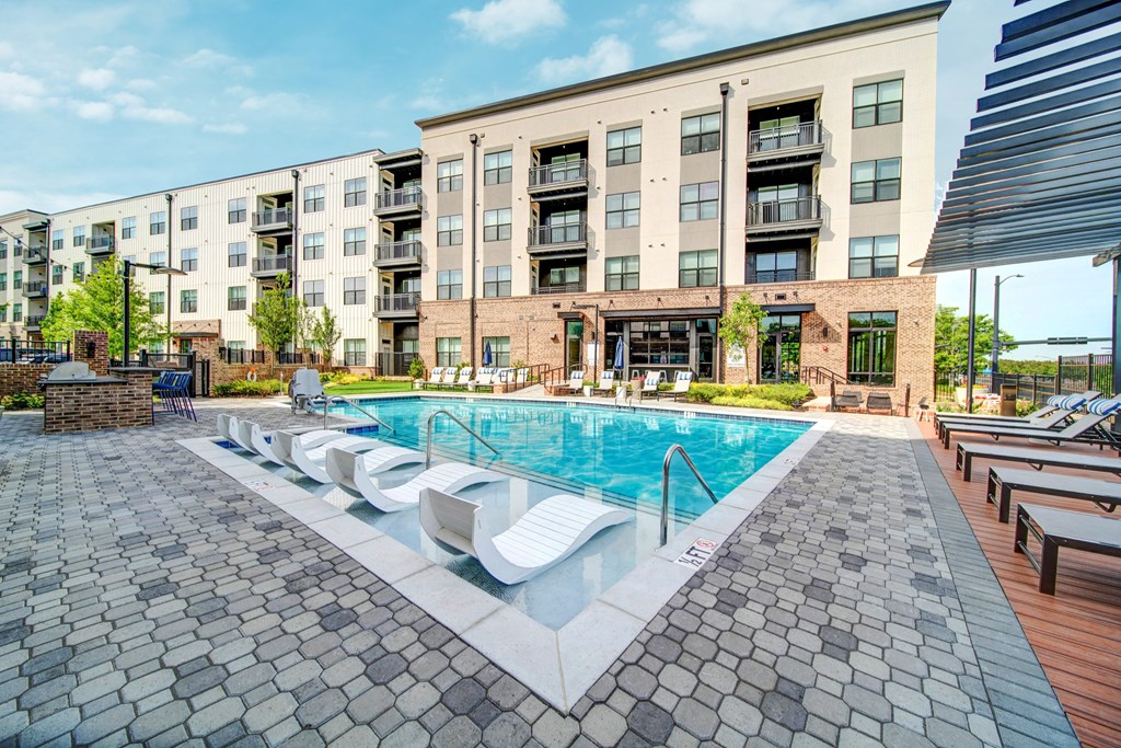 a swimming pool in front of an apartment building