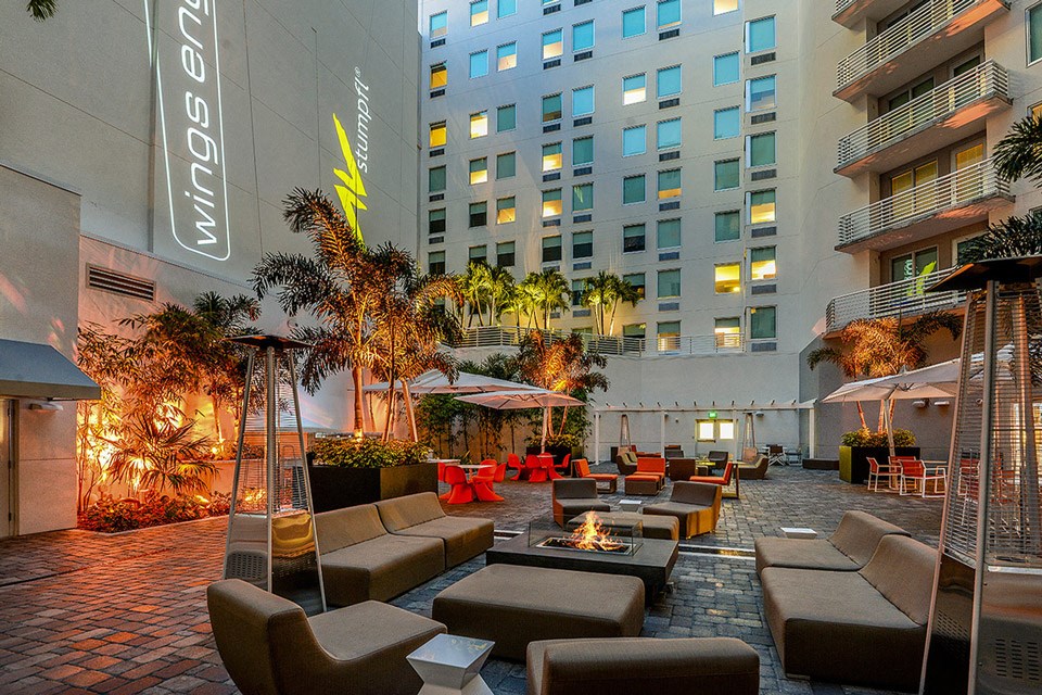 an outdoor lounge area at a hotel with a fire pit