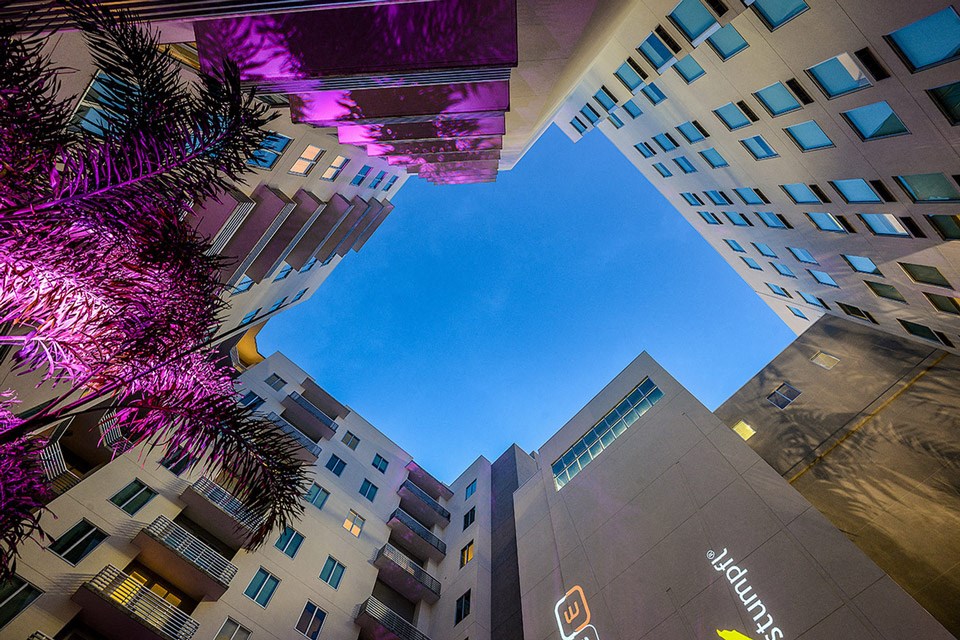 a view of buildings from the ground looking up at the sky