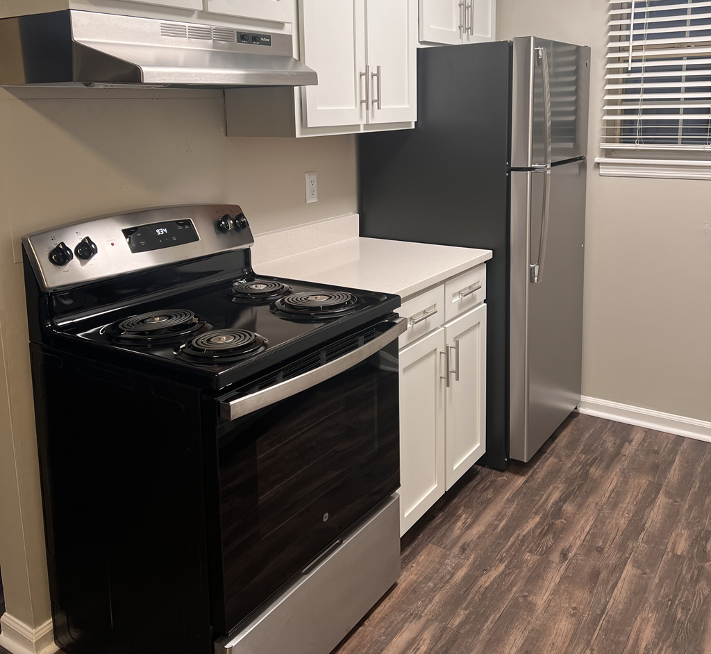 a kitchen with a stove and a refrigerator