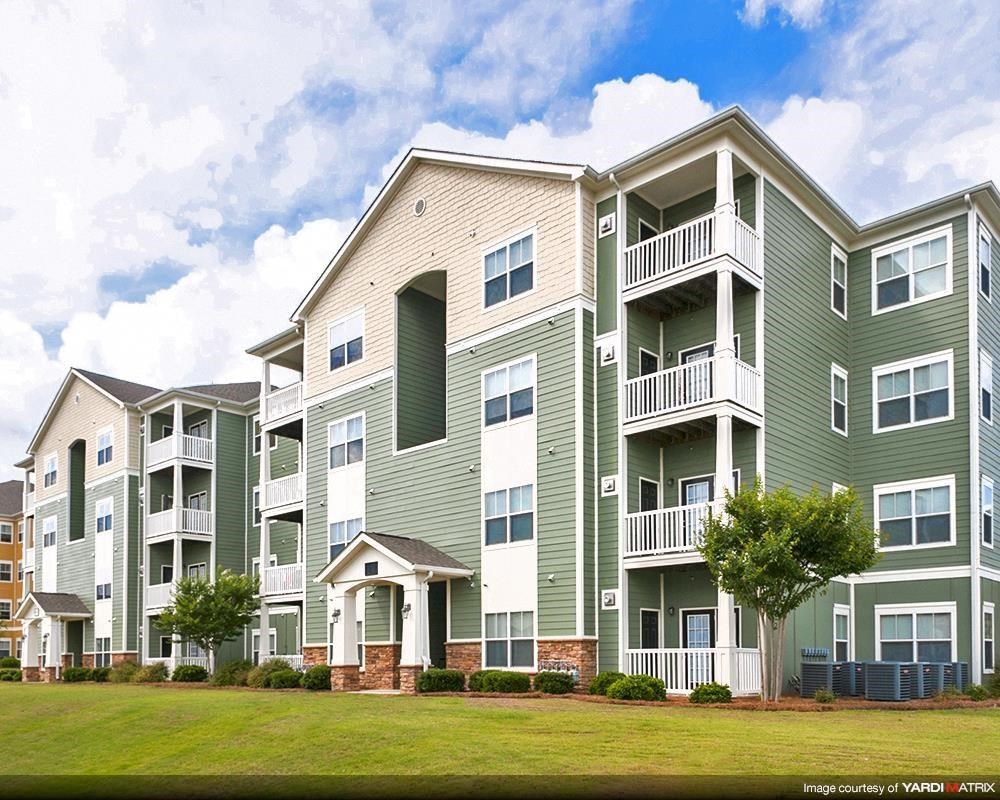 Entrance with apartment balconies and windows at the Haven at Market Street Station Aiken, SC
