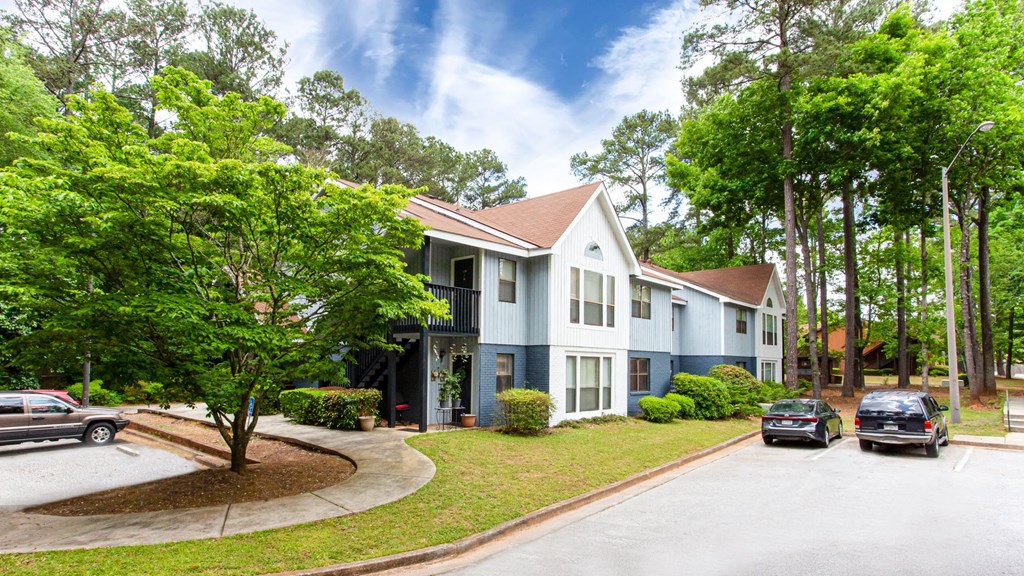 a blue and with cars parked in front of it
