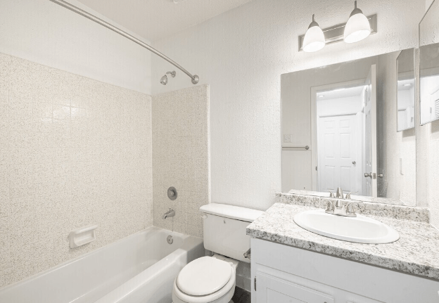 a bathroom with a sink toilet and a bath tub at Crescent Place Apartments, Savannah, GA