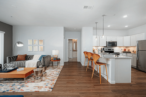 A modern kitchen with a dining table and chairs.