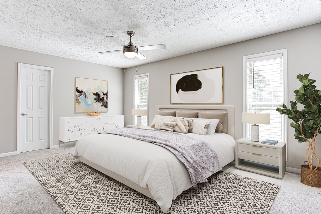 a bedroom with a bed and a ceiling fan at The Ellis Apartments, Clarkston, 30021