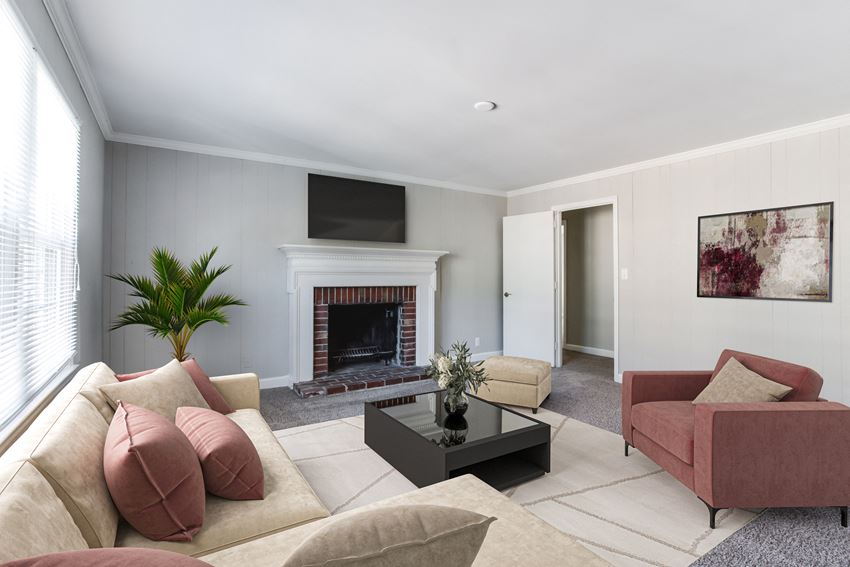 a living room filled with furniture and a fireplace  at The Mason Mills Apartments, Georgia, 30033