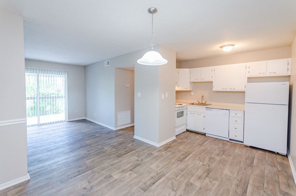 an empty kitchen and living room in an apartment at Summit East Ridge, Tennessee
