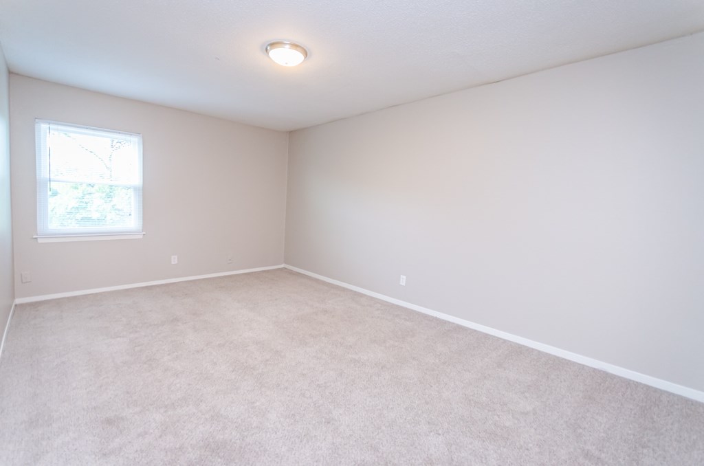a bedroom with a white carpet and a window at Summit East Ridge, Tennessee