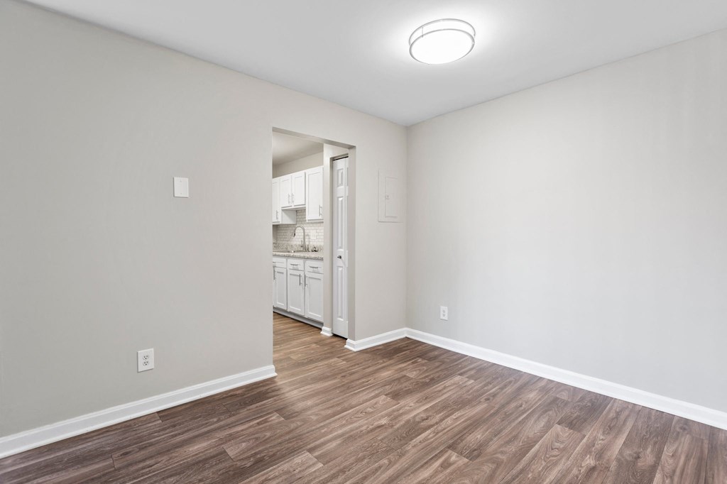 a bedroom with hardwood floors and grey walls