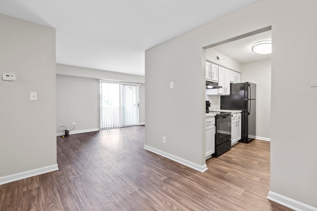 a bedroom with a medium sized bed and a kitchen with a stove and refrigerator