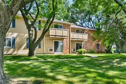 A two-story house with a balcony on the second floor.