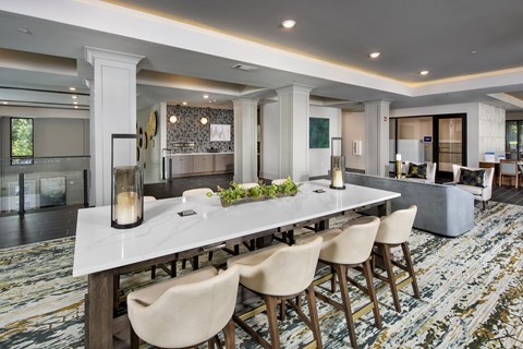 A dining room with a long table and chairs.