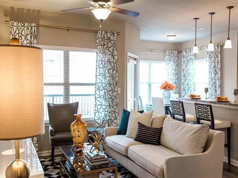 a living room with a white couch and a glass table