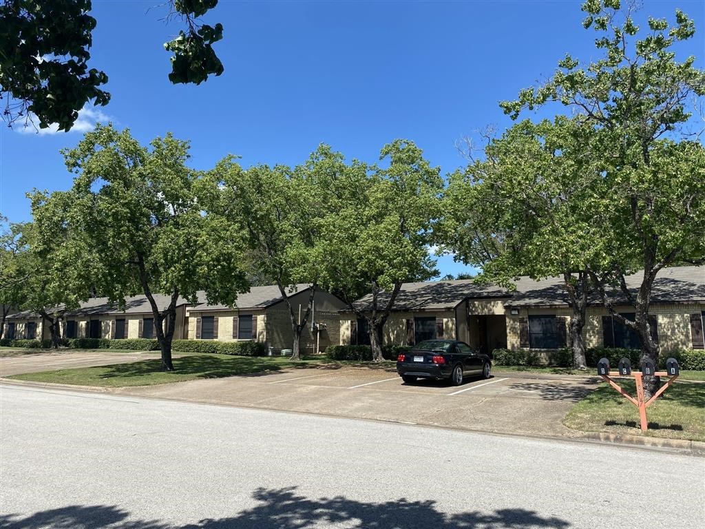 a car parked in a parking lot in front of houses