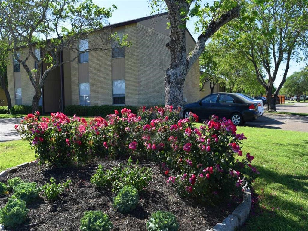 a flower garden in front of a building